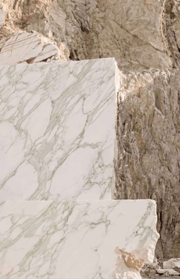 Veined marble slabs against a quarry face